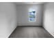 Bright bedroom featuring a window with neighborhood views and neutral carpet, offering a blank canvas at 932 Mailwood Dr, Knightdale, NC 27545