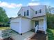 Charming two-story home boasts a spacious yard, attached garage and inviting front porch at 932 Mailwood Dr, Knightdale, NC 27545