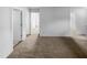 Hallway with neutral carpet and white walls, showing multiple doorways at 932 Mailwood Dr, Knightdale, NC 27545