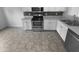 Well-equipped kitchen showcasing stainless steel appliances, white cabinets, and a mosaic tile backsplash at 932 Mailwood Dr, Knightdale, NC 27545