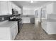 Well-lit kitchen featuring white cabinets, modern appliances, and a stylish backsplash, perfect for cooking at 932 Mailwood Dr, Knightdale, NC 27545