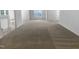 Open-concept living room with neutral carpeting and lots of natural light at 932 Mailwood Dr, Knightdale, NC 27545