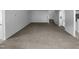 Expansive living room boasting neutral carpet and ample space with an arched doorway leading to the kitchen at 932 Mailwood Dr, Knightdale, NC 27545