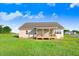 A beautiful backyard features a covered deck, sprawling grass, and picturesque trees at 9744 Bear Run Ln, Middlesex, NC 27557