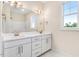 Bathroom featuring double sinks, white cabinets, white countertops, and decorative lighting at 9744 Bear Run Ln, Middlesex, NC 27557