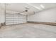 Spacious, empty garage with a sealed concrete floor and a pristine white garage door and ceiling at 9744 Bear Run Ln, Middlesex, NC 27557