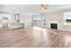 Open-concept living space with hardwood floors, fireplace, and an abundance of natural light at 9744 Bear Run Ln, Middlesex, NC 27557