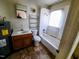Bathroom featuring a sink, toilet, and bathtub with shower, next to the water heater at 1004 Fuller St, Smithfield, NC 27577