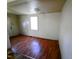 Bedroom featuring a window and a door, with laminate wood flooring at 1004 Fuller St, Smithfield, NC 27577