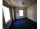 This bedroom offers natural light from its windows and a convenient closet door at 1004 Fuller St, Smithfield, NC 27577