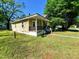 Cozy home featuring a welcoming front porch and a lush green lawn at 1004 Fuller St, Smithfield, NC 27577