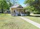 Traditional yellow home with a well-maintained lawn and mature trees, showcasing curb appeal at 1004 Fuller St, Smithfield, NC 27577