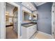 Bathroom featuring dual mirrors, granite counters, and white marble floors at 1005 Brookview Dr, Elon, NC 27244