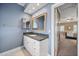 Bathroom featuring dual mirrors, granite counters, and white marble floors at 1005 Brookview Dr, Elon, NC 27244