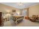 Bright bedroom with natural light, neutral decor, and comfortable seating at 1005 Brookview Dr, Elon, NC 27244