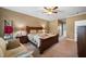 Comfortable bedroom with a ceiling fan and a doorway leading to the bathroom at 1005 Brookview Dr, Elon, NC 27244