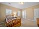 This cozy bedroom has two windows for natural light, double closets, and carpeted floors at 1005 Brookview Dr, Elon, NC 27244