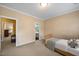 This cozy bedroom has a view of the ensuite bathroom and a walkthrough to another room at 1005 Brookview Dr, Elon, NC 27244