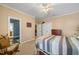 This charming bedroom has carpeted floors, neutral walls, a ceiling fan, and white closets at 1005 Brookview Dr, Elon, NC 27244