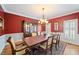 Cozy dining room showcasing a chandelier, wooden table, and shuttered windows for natural light at 1005 Brookview Dr, Elon, NC 27244