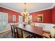 Inviting dining room with warm lighting, a wooden table, and an open entryway for gatherings at 1005 Brookview Dr, Elon, NC 27244