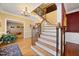 Stunning foyer with wooden staircase, a decorative chandelier, and hardwood floors, creating a welcoming entrance at 1005 Brookview Dr, Elon, NC 27244