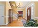 Grand foyer featuring hardwood floors, a staircase with wrought iron railing, and a chandelier at 1005 Brookview Dr, Elon, NC 27244
