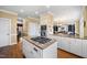 Kitchen featuring granite counters, stainless steel appliances, a cooktop island, and white cabinetry at 1005 Brookview Dr, Elon, NC 27244