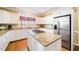 Spacious kitchen featuring white cabinets, stainless steel appliances, granite countertops, and center island at 1005 Brookview Dr, Elon, NC 27244