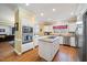 Kitchen with stainless appliances, center island, white cabinets, and eat-in counter at 1005 Brookview Dr, Elon, NC 27244