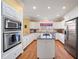 Well-lit kitchen features stainless steel appliances, granite counters, and a functional center island at 1005 Brookview Dr, Elon, NC 27244