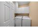 Dedicated laundry room with washer, dryer, and built-in cabinets for storage at 1005 Brookview Dr, Elon, NC 27244