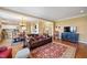 Open living room with yellow walls, a fireplace, and an adjacent kitchen and dining area at 1005 Brookview Dr, Elon, NC 27244