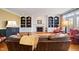 Inviting living room with built-in shelving, a brick fireplace, and plush leather furniture at 1005 Brookview Dr, Elon, NC 27244
