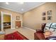 Cozy room with a bookshelf and an armchair, featuring carpeted floors at 1005 Brookview Dr, Elon, NC 27244