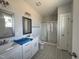 Main bathroom with double vanities, a glass-enclosed shower, and decorative tile flooring at 102 Ruskin Dr, Smithfield, NC 27577