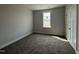 This bedroom offers natural light from a window and features a closet and neutral carpet at 102 Ruskin Dr, Smithfield, NC 27577