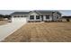 Charming single-story home with gray siding, stone accents, and an attached two-car garage at 102 Ruskin Dr, Smithfield, NC 27577