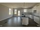 Bright, unfinished kitchen boasts white cabinetry, an island, and modern pendant lighting at 102 Ruskin Dr, Smithfield, NC 27577