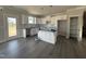 Open concept kitchen with white cabinets, a center island, and backyard access at 102 Ruskin Dr, Smithfield, NC 27577