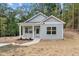 Charming single-story home with a modern gray exterior and inviting front entrance at 111 Halifax Rd, Louisburg, NC 27549