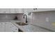 Close-up of a kitchen counter with a granite countertop and a stainless steel sink at 111 Halifax Rd, Louisburg, NC 27549