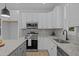 Modern kitchen features stainless steel appliances, granite counters, and white cabinetry at 111 Halifax Rd, Louisburg, NC 27549