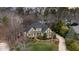 Aerial view of a large home with mature trees and manicured landscaping in a wooded community at 111 San Juan Dr, Chapel Hill, NC 27514
