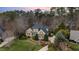 Aerial view of a large home with mature trees and manicured landscaping in a wooded community at 111 San Juan Dr, Chapel Hill, NC 27514