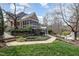 Landscaped backyard with walkway, screened in porch, hot tub, and swimming pool with slide at 111 San Juan Dr, Chapel Hill, NC 27514