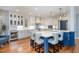 Spacious kitchen with white cabinets, a large island, stainless steel appliances, and hardwood floors at 111 San Juan Dr, Chapel Hill, NC 27514