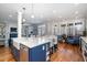 Spacious kitchen with large island, white cabinets, and open access to a living room at 111 San Juan Dr, Chapel Hill, NC 27514