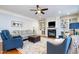 Cozy living room with a fireplace, built-in shelving, and hardwood floors at 111 San Juan Dr, Chapel Hill, NC 27514