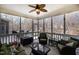 The cozy screened porch is furnished with seating and glass table at 111 San Juan Dr, Chapel Hill, NC 27514